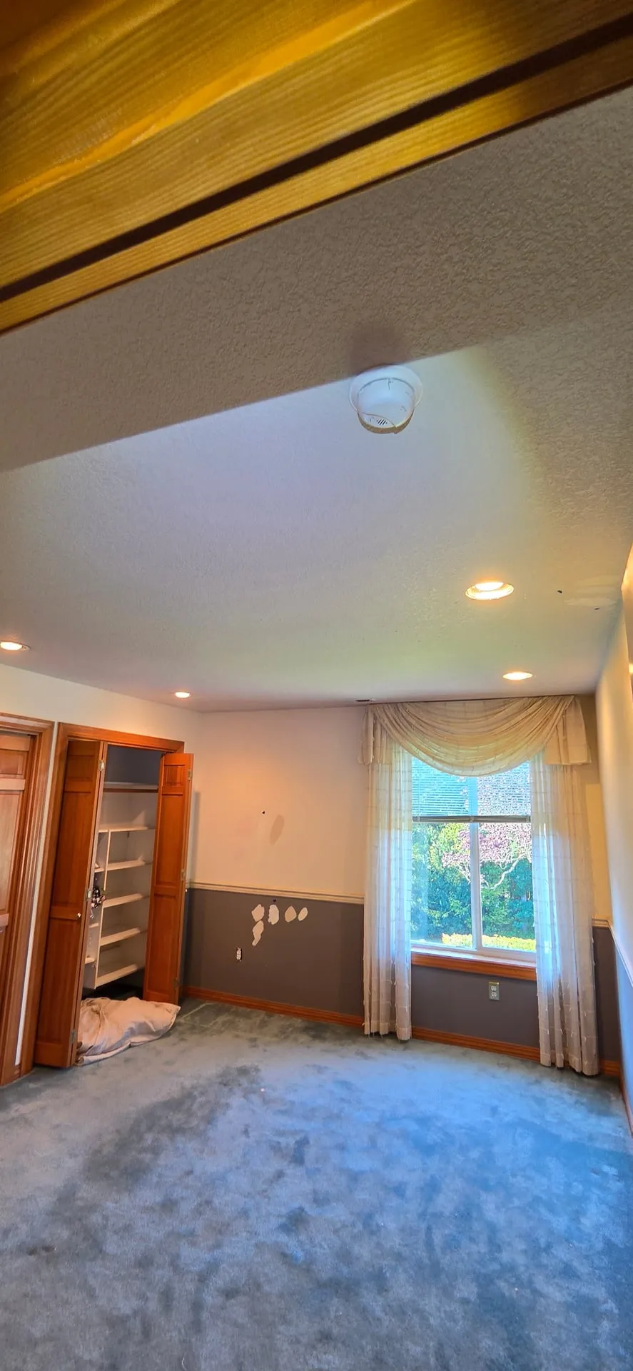 Brush Prairie WA bedroom with new recessed lights in a textured ceiling, a closet with open doors and a window with a valance