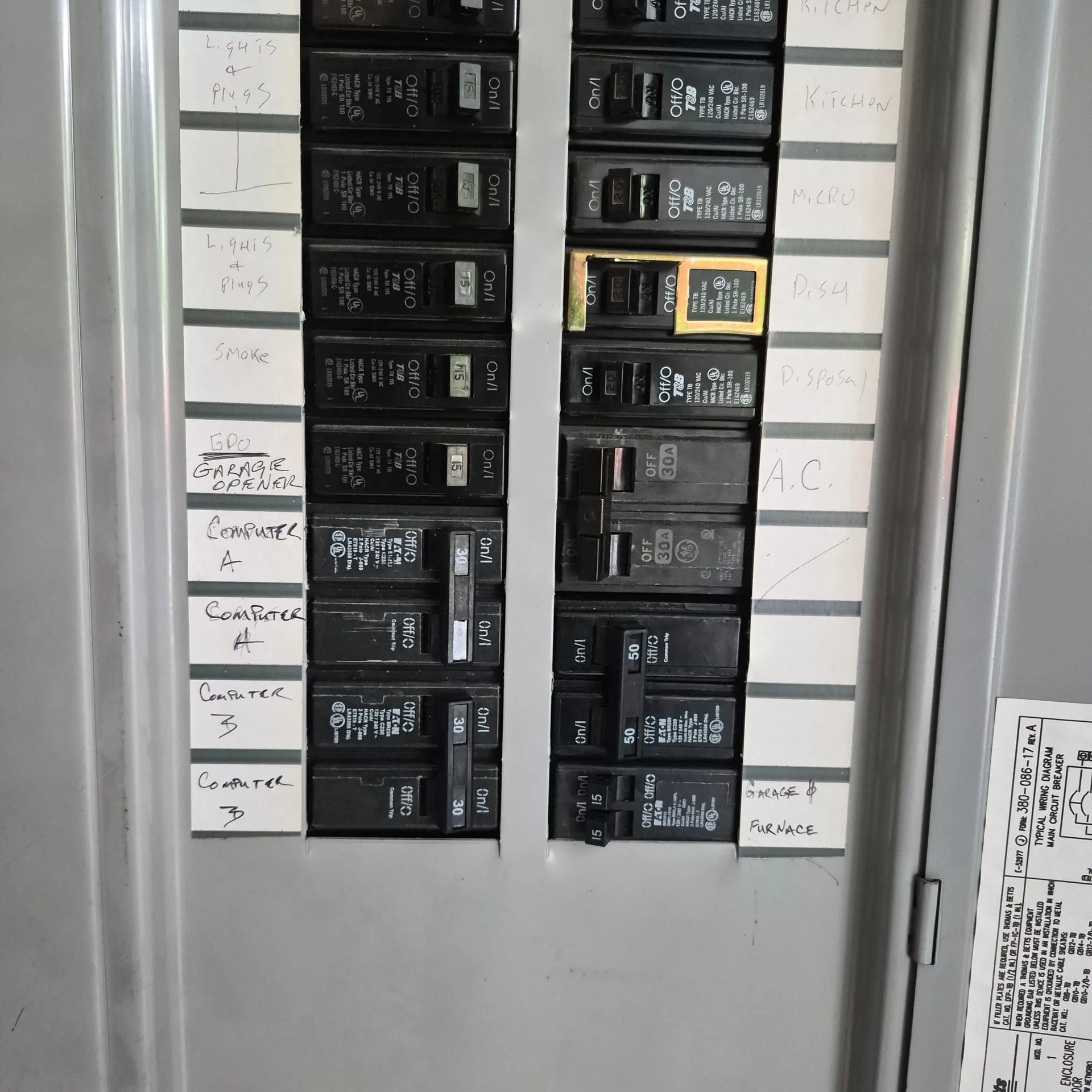 Open GE electrical panel in a Vancouver WA home with two new dedicated 30-amp breakers labeled Computer A and Computer B added alongside the existing kitchen, AC, and appliance circuits