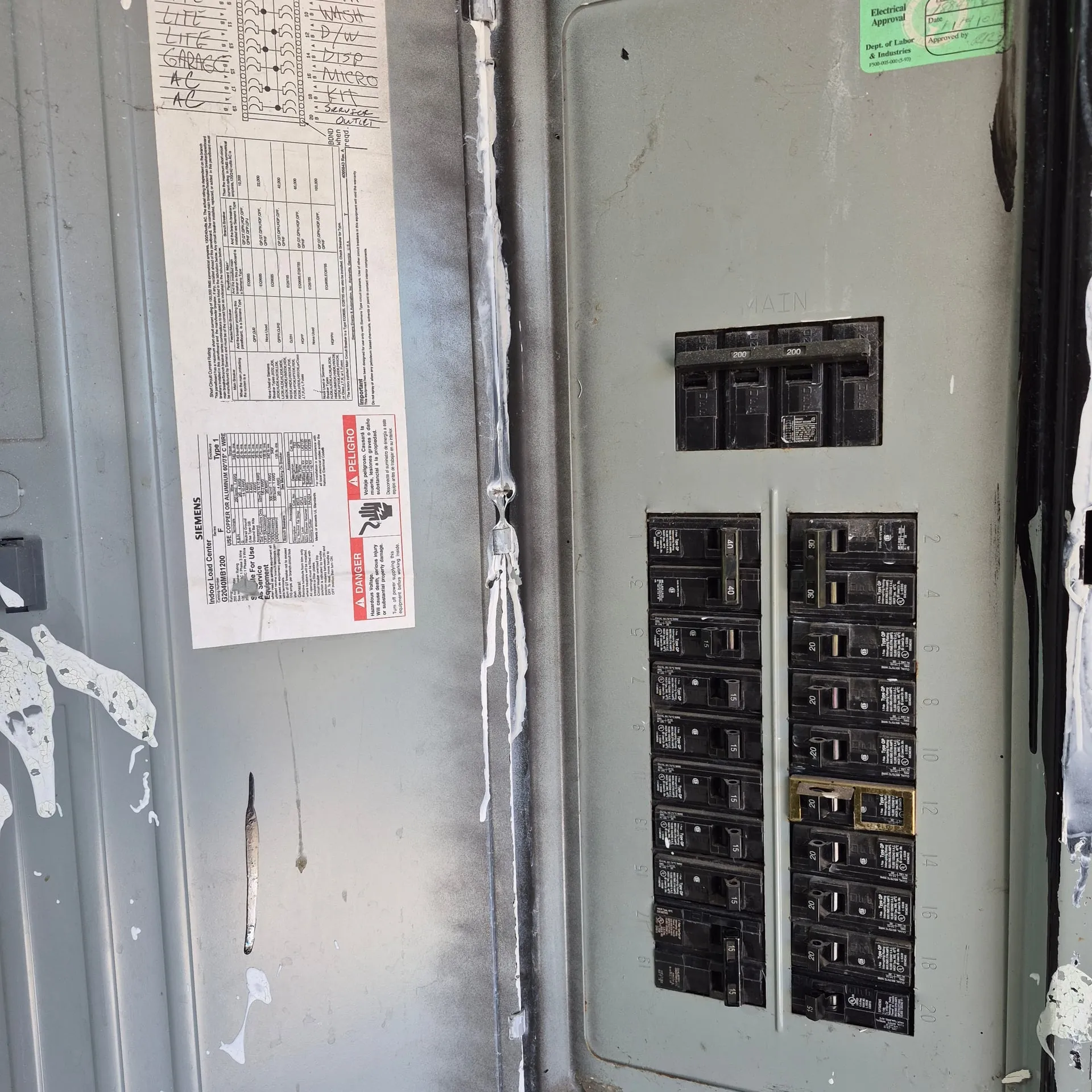 Open 200-amp Siemens electrical panel inside a Vancouver WA home showing the main breaker, branch circuits, and the load directory taped to the cover where the A/C circuit was added