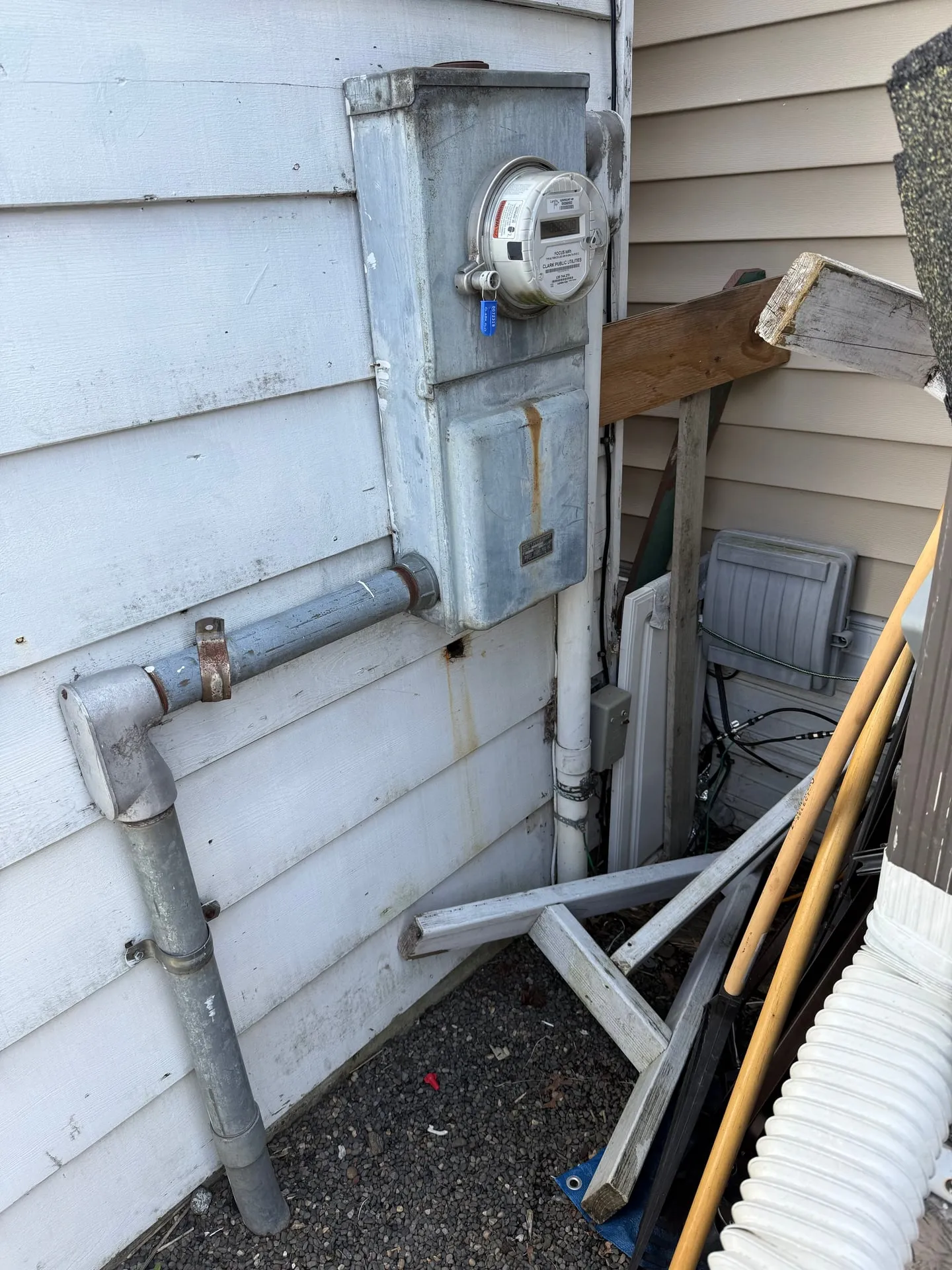 Exterior meter base and service conduit on a manufactured home in Vancouver WA, the point where the new carport light circuit ties into the unit's own power