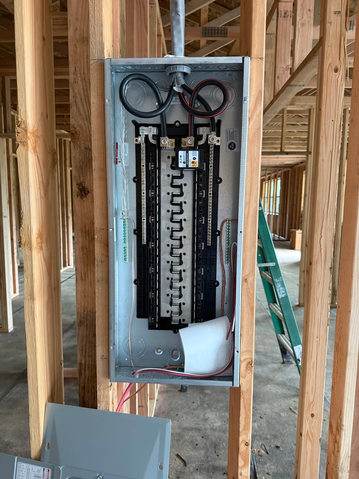40/80-space Eaton MLO main lug panel with integrated whole-house surge protector, mounted during the rough-in phase of a Vancouver WA new construction home