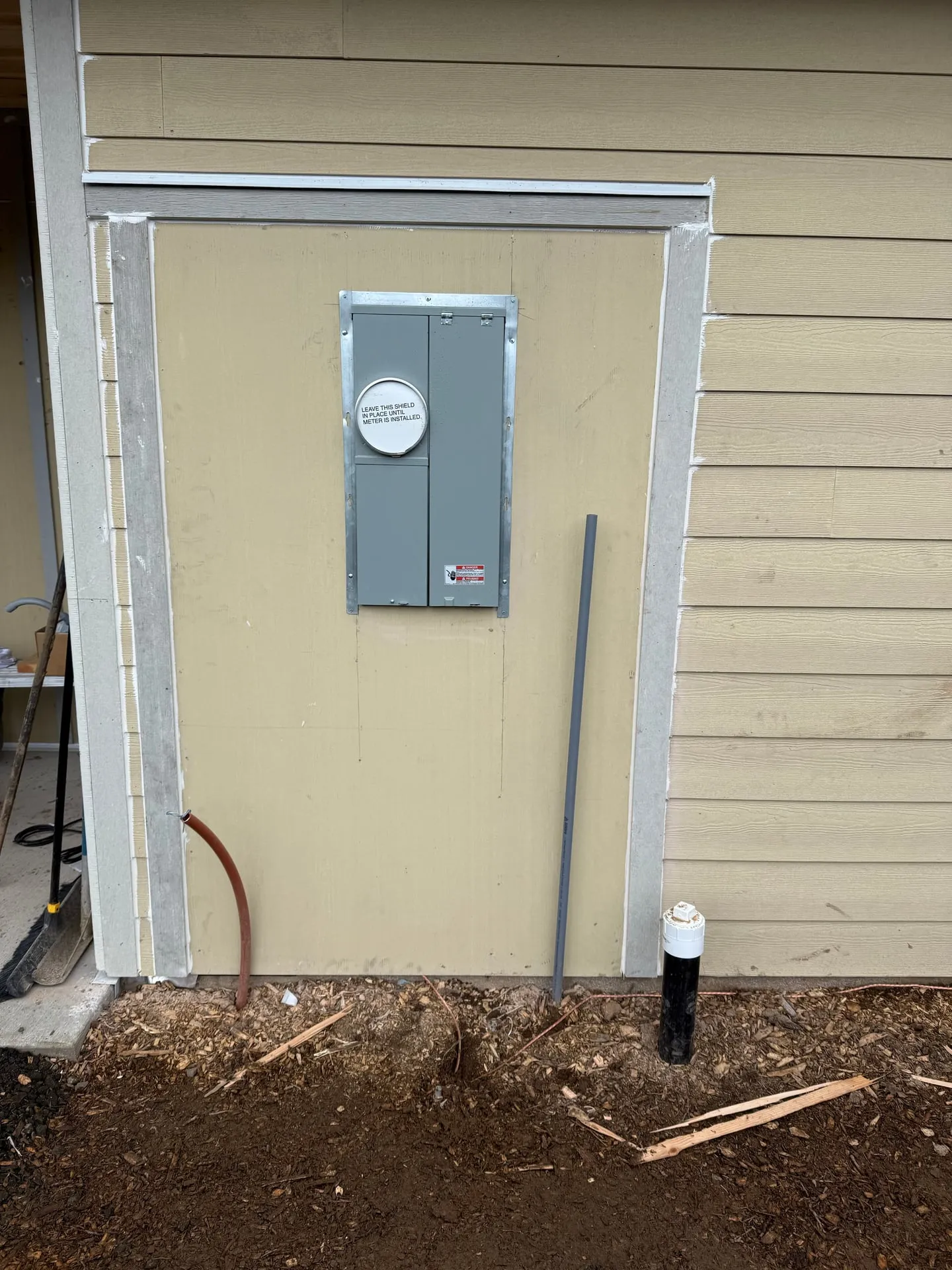 Recessed 200-amp meter main on the exterior wall of a new construction home in Vancouver, WA, sealed and ready for utility meter installation by Newman Electric