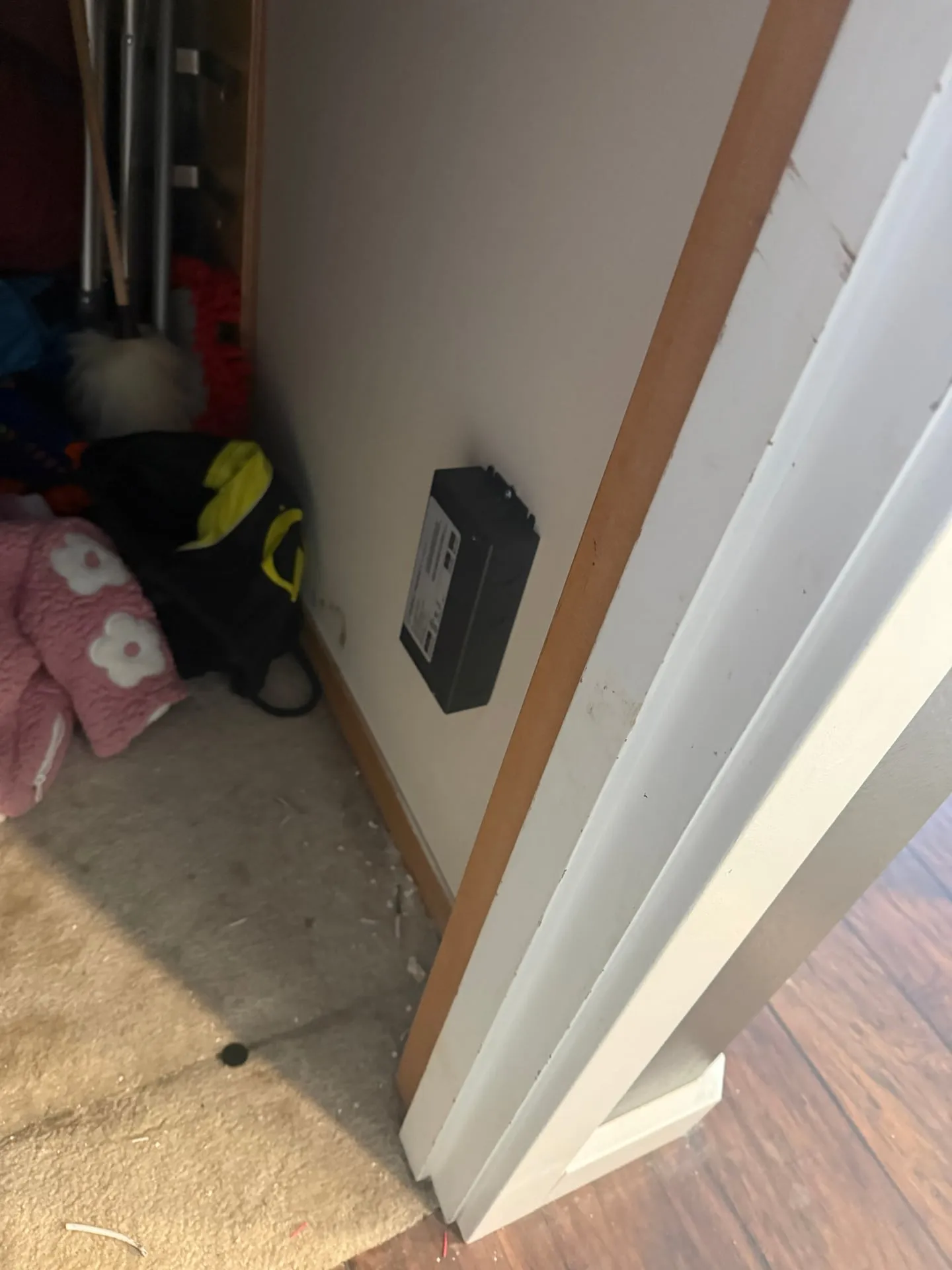 Black LED driver box mounted low on a closet wall beside a door frame in a Washougal WA home