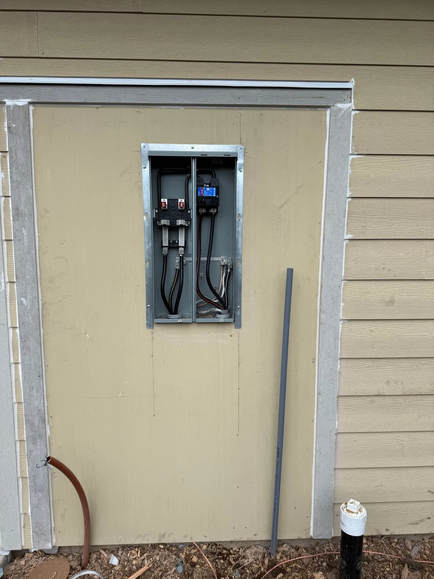 Interior view of the 200-amp meter main showing service entrance conductors and disconnect connections during the rough-in phase of a Vancouver WA new build