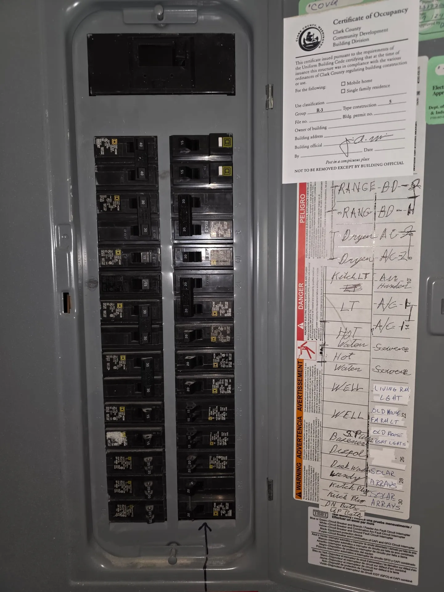 Existing Square D Homeline panel at a Felida home in Vancouver WA with handwritten circuit labels including dedicated solar array breakers